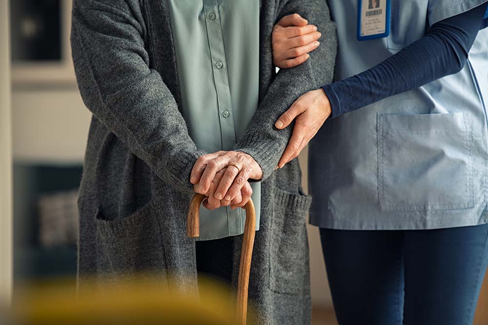 Nurse assisting senior citizen